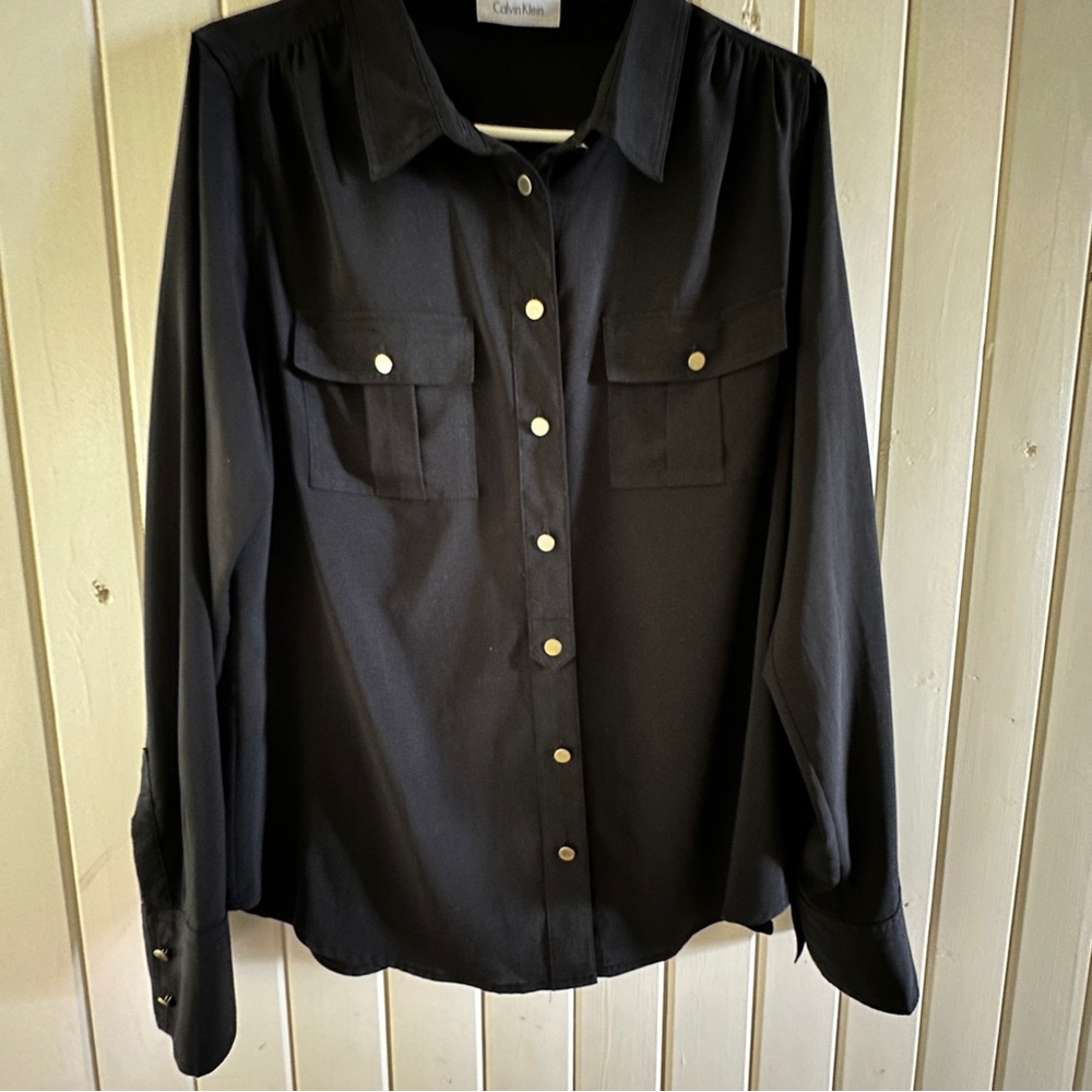 Calvin Klein black shirt, new condition, size L. Front pockets, gold buttons.
